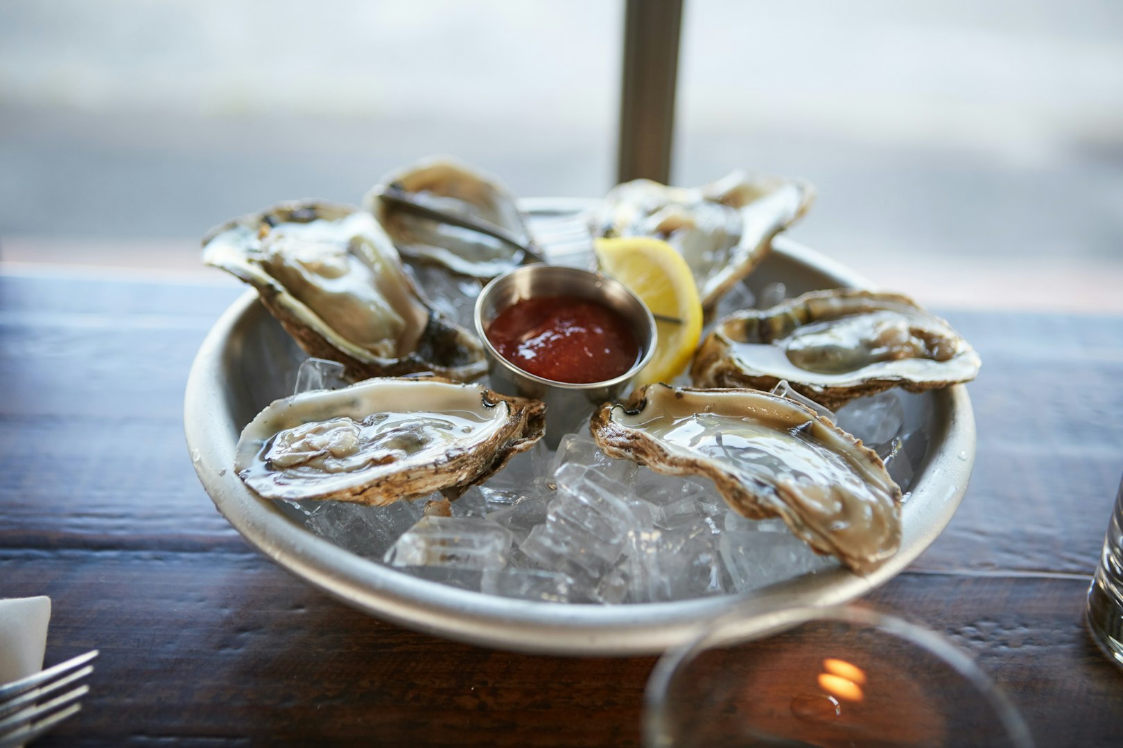 Oysters on ice with lemon and cocktail sauce